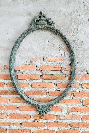Vintage oval photo frame on brick wallの写真素材