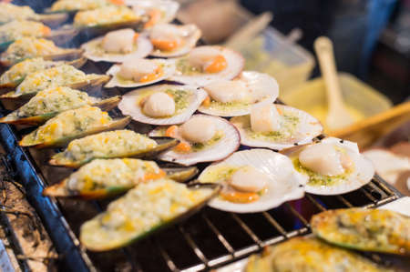 Grilling oysters food on the flaming grill