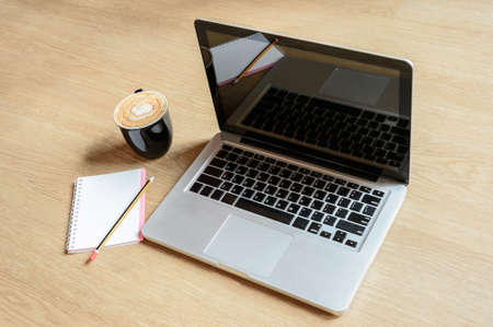 Wood office table with laptop and notebook. Top view with copy spaceの写真素材