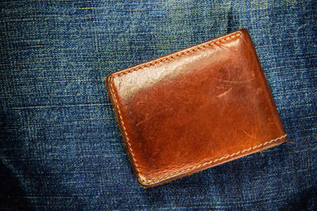 Brown leather wallet on jeans backgroundの写真素材