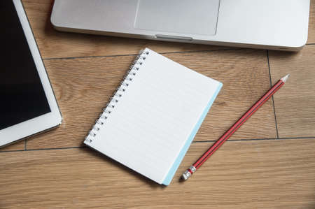Wood office table with laptop and notebook. Top view with copy spaceの写真素材