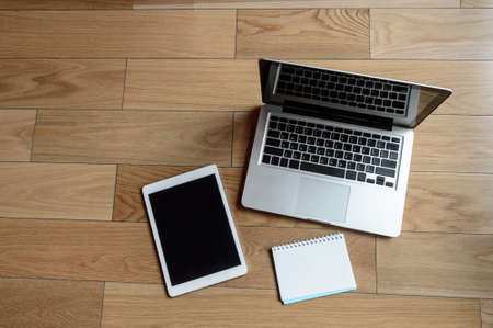 Wood office table with laptop and notebook. Top view with copy spaceの写真素材