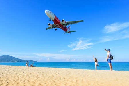 PHUKET, THAILAND - FEB 4 , 2017: Tourists are running to see the airplane landing at the beach nearby (Phuket) International Airport, south of Thailand.のeditorial素材