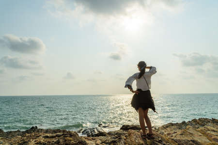 The girl enjoy life on top of the seaの写真素材