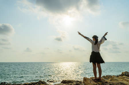 The girl enjoy life on top of the seaの写真素材