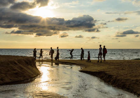People enjoy sunset on the beachの写真素材