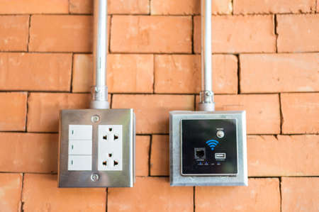 electric plug and wifi connector on the wall