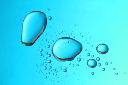 Water drops over blue surface                               の写真素材