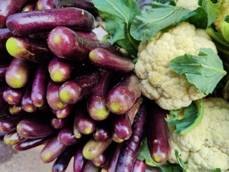 Fresh eggplants and cauliflower for sale at a farmers marketの写真素材