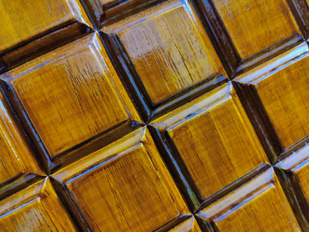 close up of a brown wooden background with square tiles in a rowの写真素材