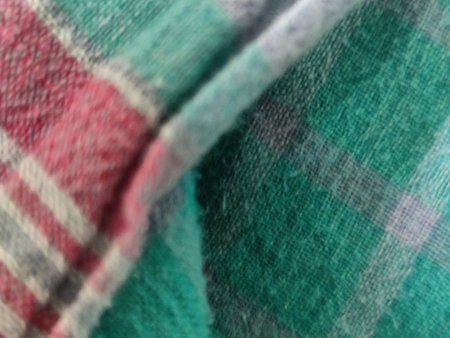 Blurry background of woolen plaid fabric. Abstract background.の写真素材