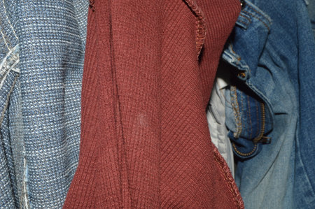 clothing on hangers in a store, closeup of photoの写真素材