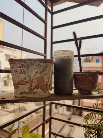 Three clay pots on the balcony with a view of the city.の写真素材