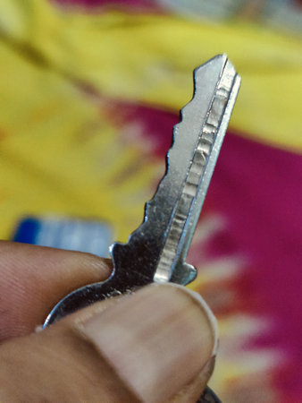 Close-up of a key being held by a man's hand