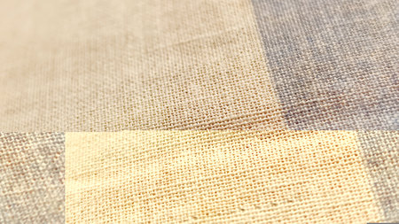 Closeup detail of beige and brown fabric texture samples background.