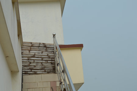Staircase on the roof of a building with blue sky background