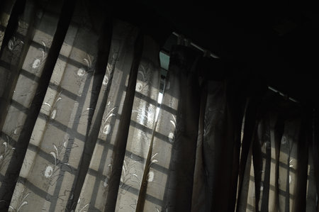 Curtains in the window with blinds, closeup of photo