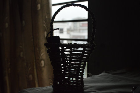 Wicker basket on the windowsill in the interior of the roomの写真素材