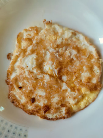 Cheese omelette on white plate, Thailand. (Selective focus)
