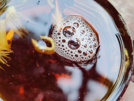 Cup of black tea with lemon, close-up, macro
