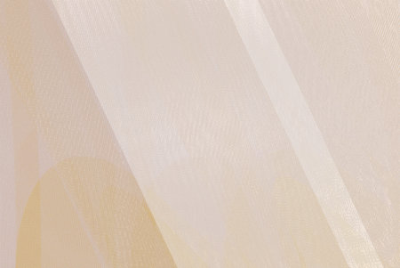 Texture, background, pattern. The fabric is transparent, beige, brown, yellow. It is transparent, has a beautiful drapery.の写真素材