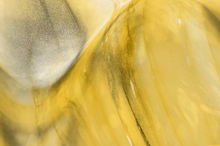 abstract gold background, close-up of golden paint on canvas