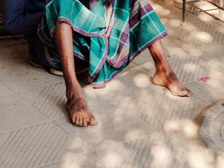 Indian man sitting on the floor and wearing a green shawlの写真素材