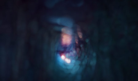 A moody, abstract image of blue neon lights and blurred bokeh creating a deep, atmospheric scene....