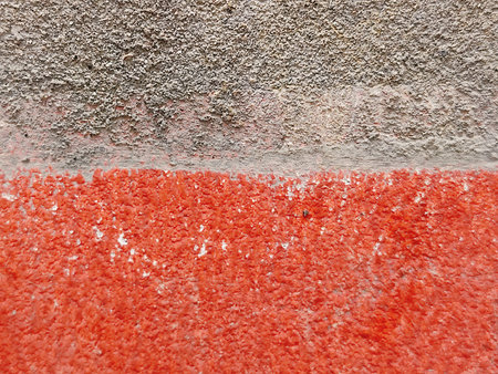 Old concrete wall with red paint. Background and texture for design.