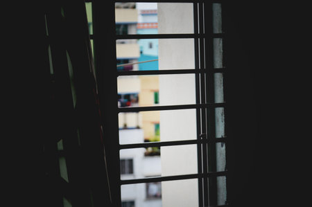 Window with blinds in the city. Close-up. Selective focus.