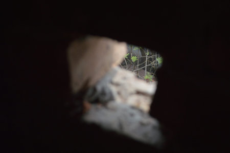 abstract background of stone wall and hole in the wall with shadowの写真素材
