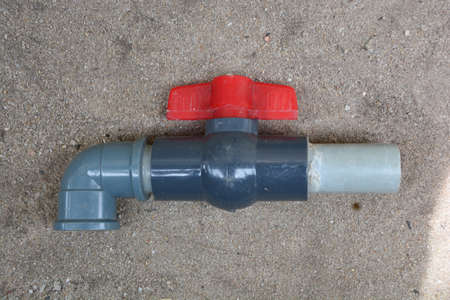 Detached plastic faucet place on a sandy floor