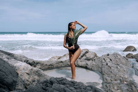 A traveler sexy woman resting on the Tropical island with white paradise sand beach and turquoise clear water and granite stones.の写真素材