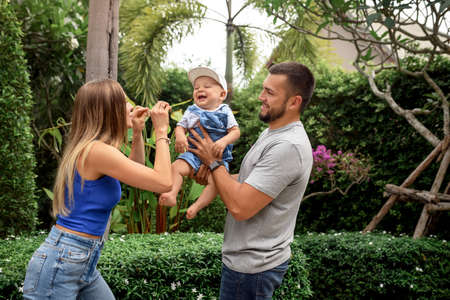Family outdoors. family of three having fun and playing outdoors. happy family conceptの写真素材