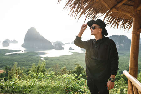 Stylish young man resting on beautiful natureの写真素材