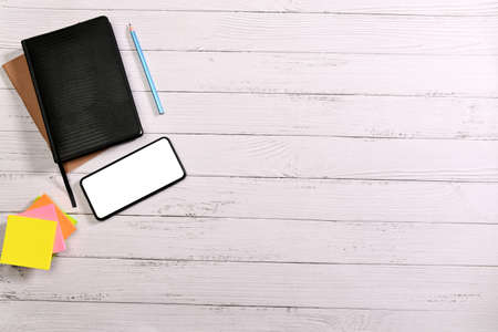 Top view: stationery on a white desk