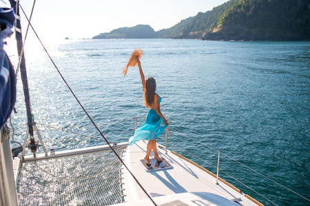 attractive model woman in a bikini and long skirt on a yachの写真素材