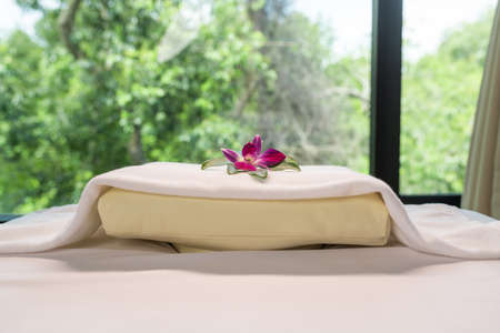 White bed and towels with flower settingの写真素材