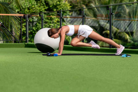 gorgeous brunette goes in for sports in natureの写真素材