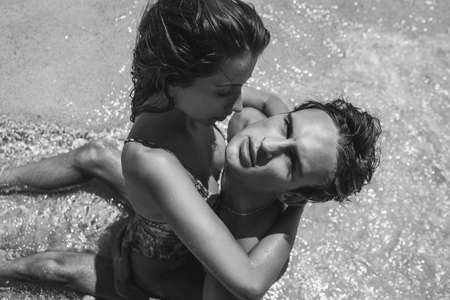 A couple in white clothes is resting on the beach of a wonderful islandの写真素材