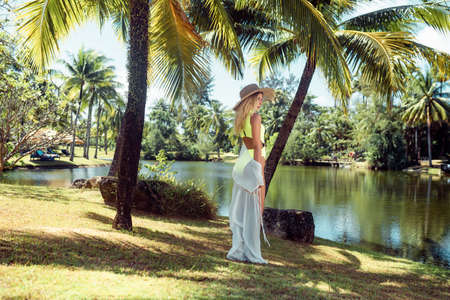 Tender young blonde is resting on a tropical vacation