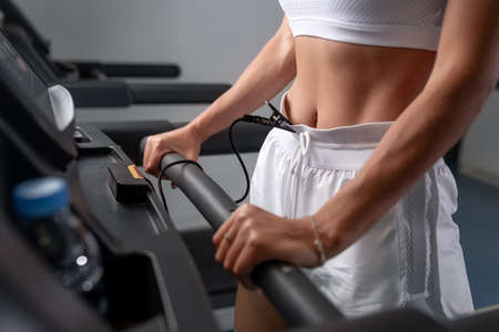 Stunning brunette in white sports lingerie goes in for sports in the gymの写真素材