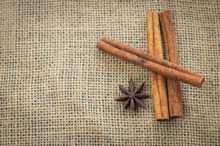 cinnamon sticks on sacking background.