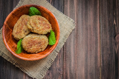 Cutlets in a plate on a wooden background.の写真素材