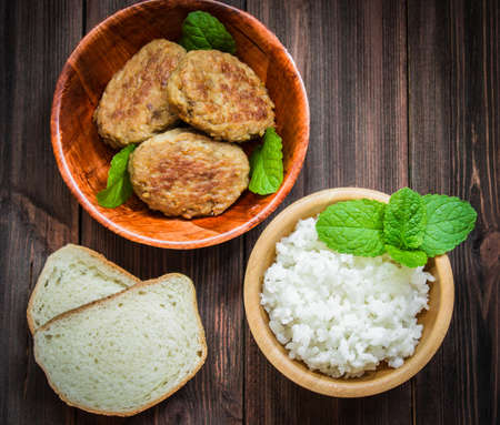 Cutlets with white rice in a bowl.の写真素材