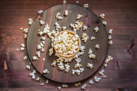 Salt popcorn on the wooden table, selective focusの写真素材