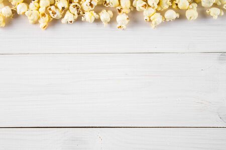 Salted popcorn on a white table. Top view. Empty space for textの写真素材