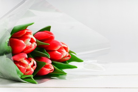 Bouquet of pink tulips on white wooden background. Top view, copy space.. Happy mother's day.の写真素材