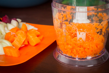 Carrots for borsch in an electric chopper. Soup cookingの写真素材
