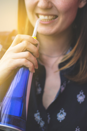 A woman using an oral irrigator in bathroom. Selective focus.の写真素材